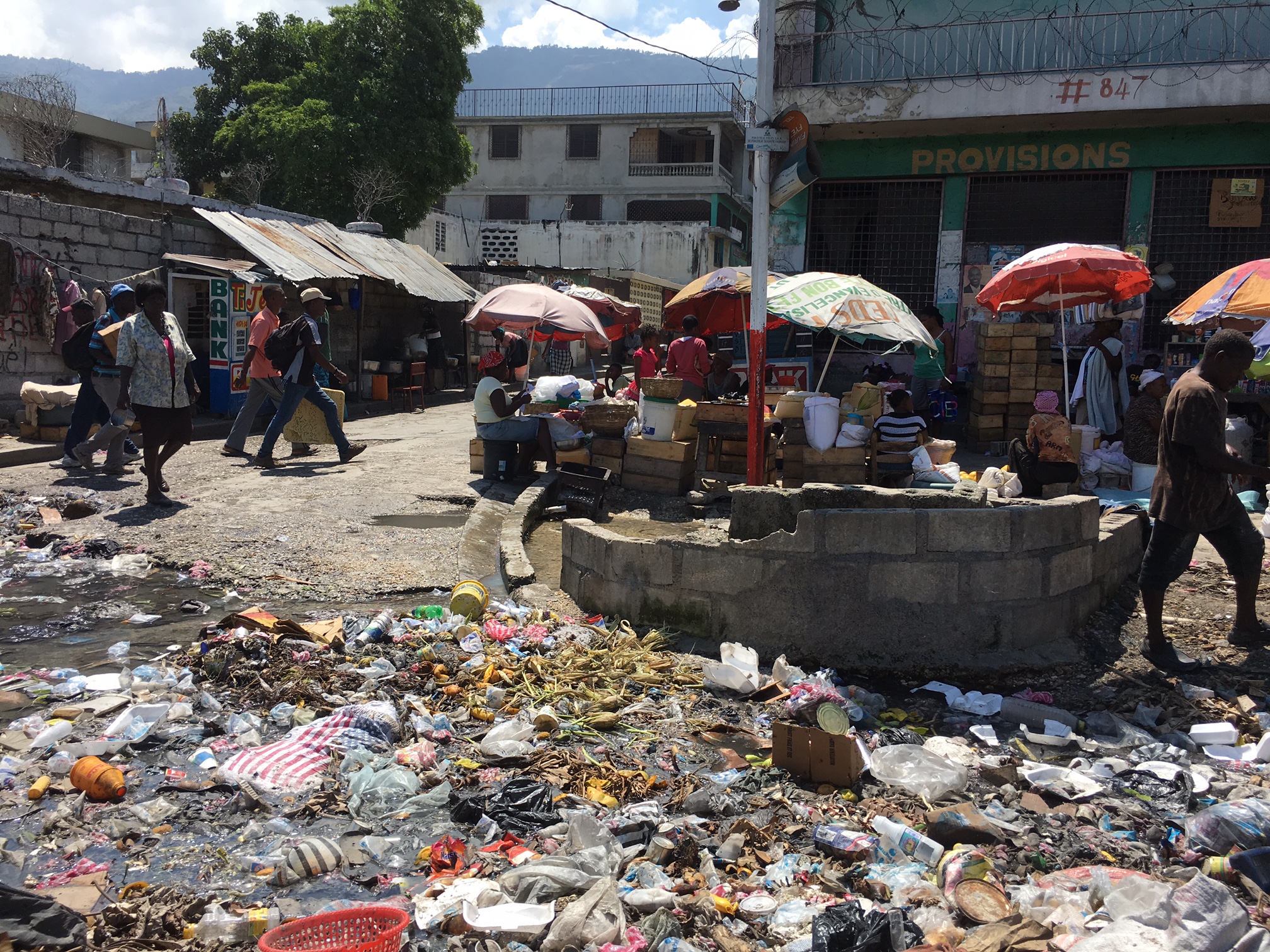 Haitian Street Market in Port-au-Prince, rice from the United States trashed in the gutter